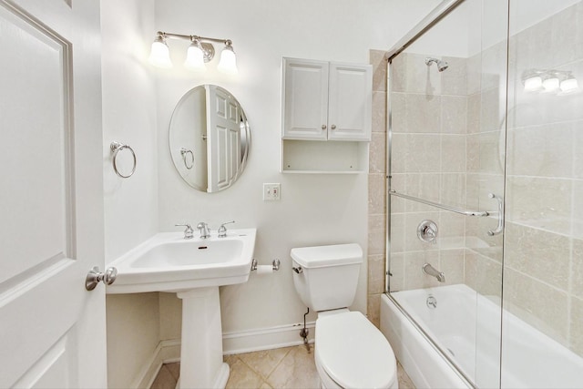 bathroom featuring toilet, tile patterned floors, and shower / bath combination with glass door