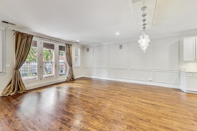 unfurnished room with crown molding and hardwood / wood-style floors