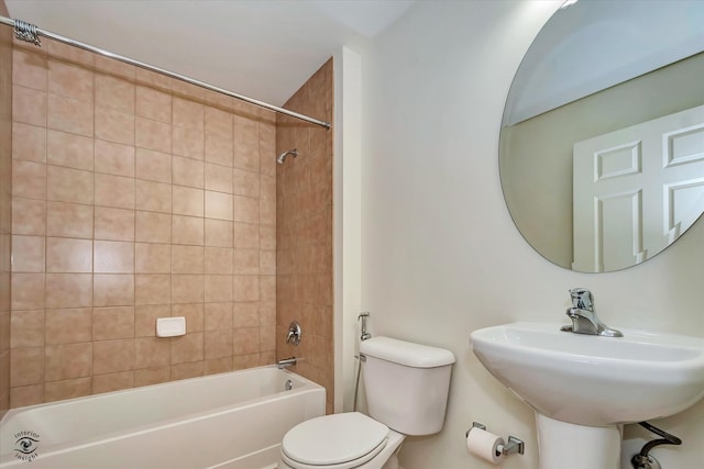 full bathroom with toilet, tiled shower / bath combo, and sink