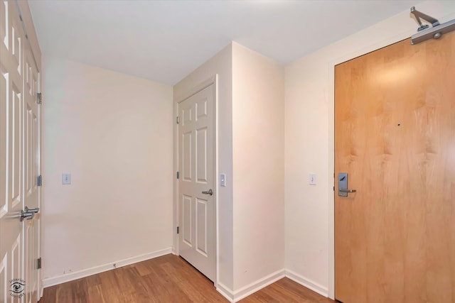 entryway with hardwood / wood-style floors