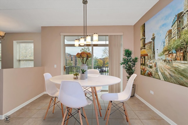 tiled dining area with a notable chandelier