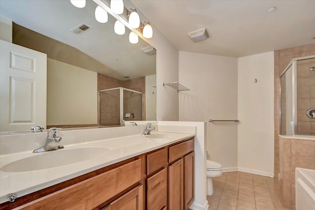 bathroom with a shower with door, toilet, tile patterned floors, and vanity