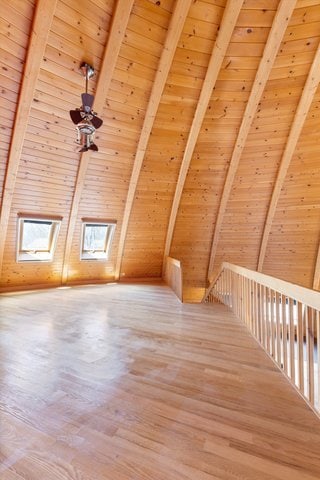 bonus room with wood ceiling and wood-type flooring