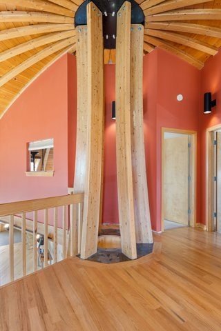 interior space featuring hardwood / wood-style floors and lofted ceiling with beams