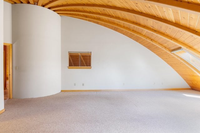 bonus room with wood ceiling, carpet, and vaulted ceiling with beams