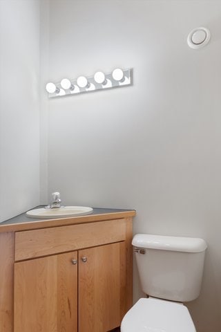 bathroom featuring vanity and toilet