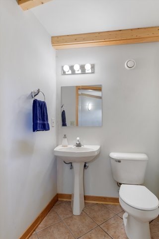 bathroom with tile patterned floors and toilet