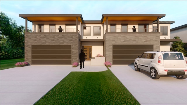 view of front of property with a balcony, a front yard, and a garage