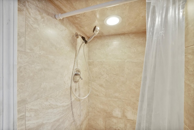 interior details featuring a shower with shower curtain