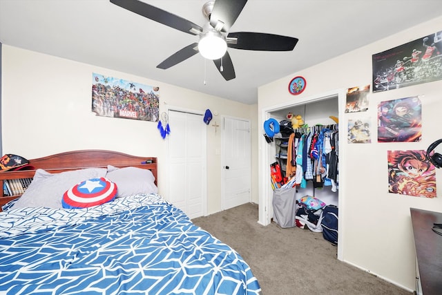 carpeted bedroom with multiple closets and ceiling fan