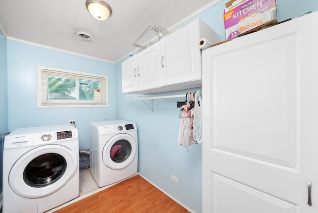 washroom with independent washer and dryer, crown molding, cabinets, and light wood-type flooring