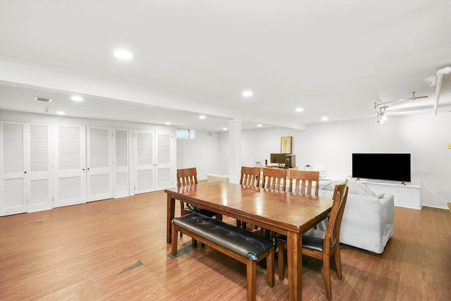 dining space featuring wood-type flooring