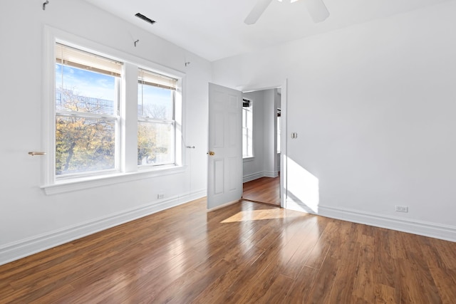 spare room featuring wood-type flooring and ceiling fan