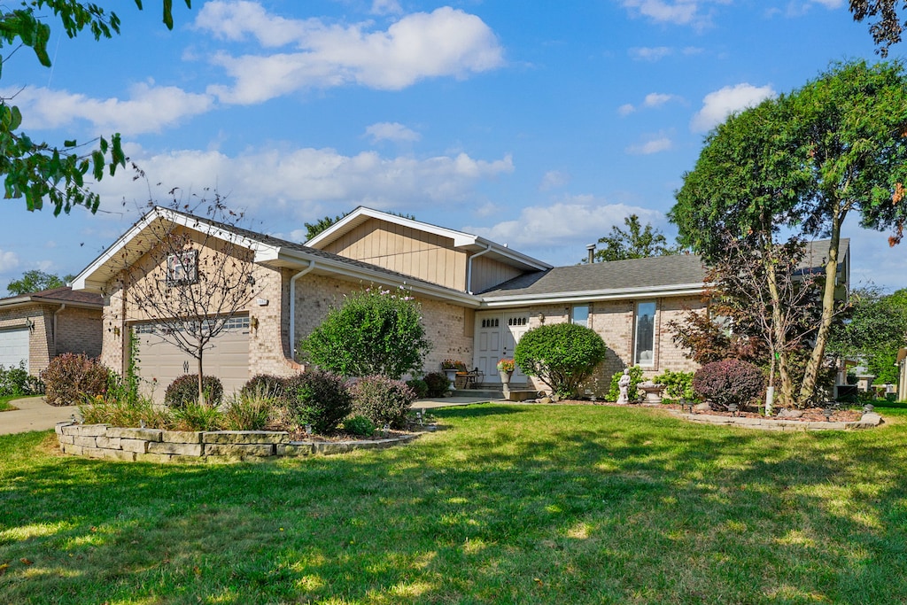 view of front facade with a garage and a front lawn