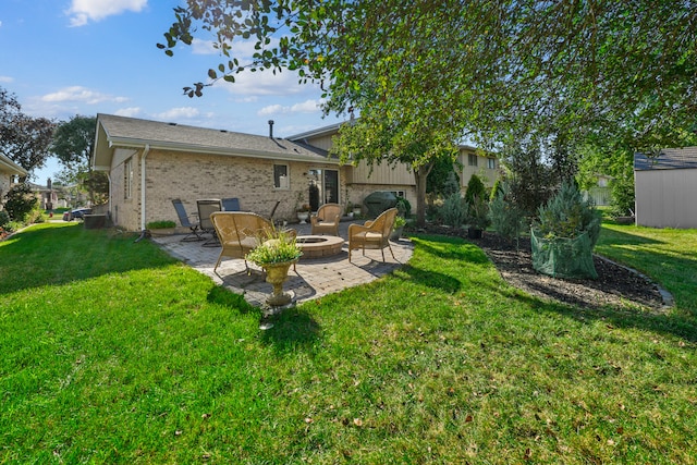 back of property with a storage unit, a yard, and a patio area