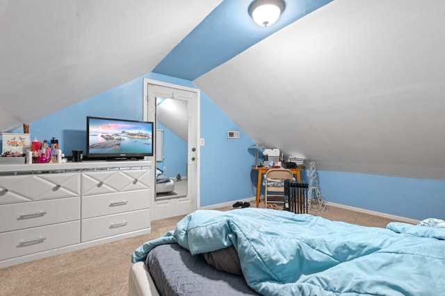 carpeted bedroom with lofted ceiling