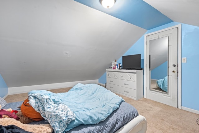 bedroom featuring vaulted ceiling and light colored carpet