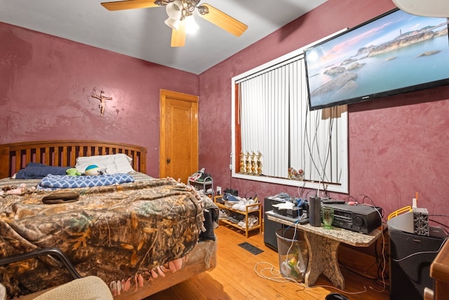 bedroom with light wood-type flooring and ceiling fan