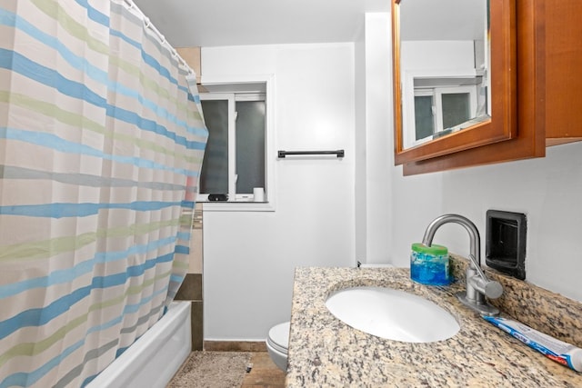 full bathroom featuring toilet, shower / bath combination with curtain, and vanity