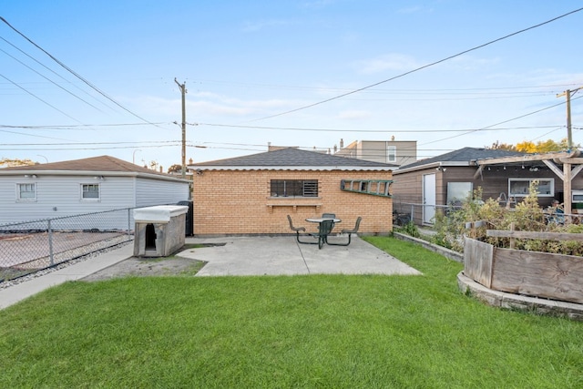 back of house with a yard and a patio