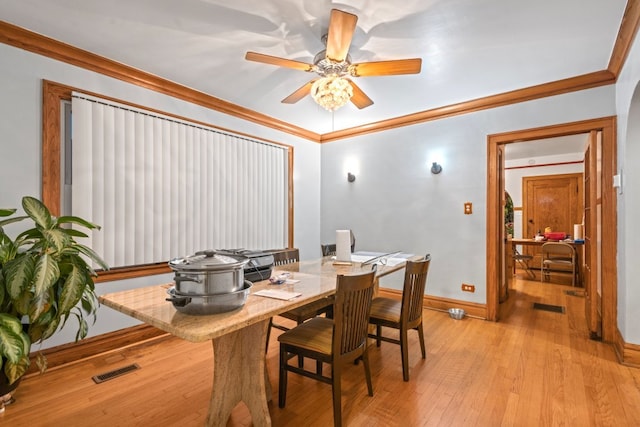 dining space featuring crown molding, light hardwood / wood-style floors, and ceiling fan