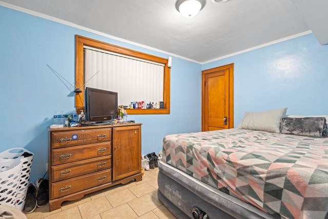 bedroom with crown molding and light tile patterned flooring