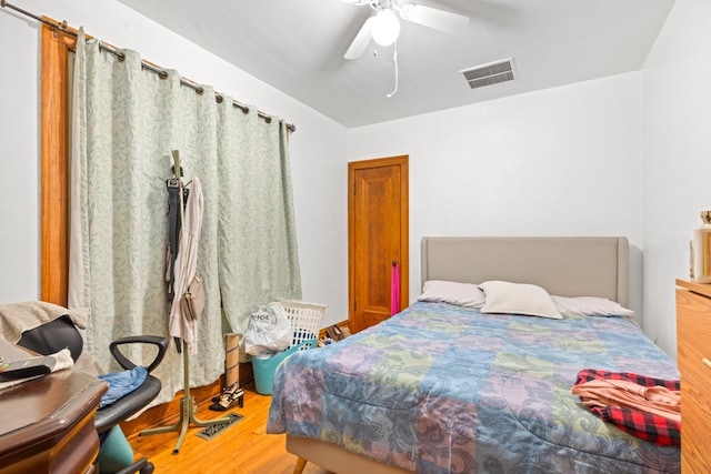 bedroom with light hardwood / wood-style flooring and ceiling fan