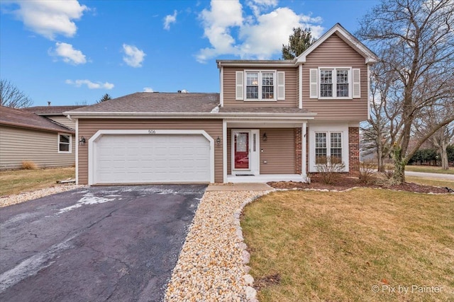 view of front property with a garage and a front lawn