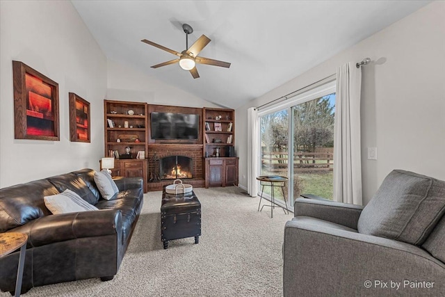 living room with carpet flooring, ceiling fan, vaulted ceiling, and a brick fireplace