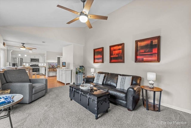 carpeted living room featuring ceiling fan and lofted ceiling