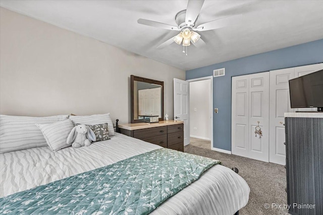 bedroom featuring dark colored carpet, a closet, and ceiling fan