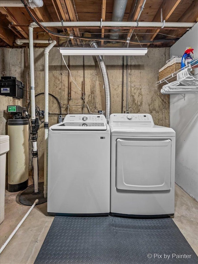 clothes washing area featuring washer and clothes dryer