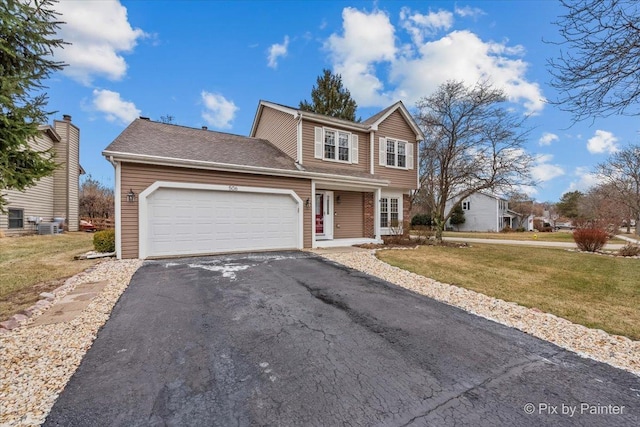 front facade featuring a front yard and a garage