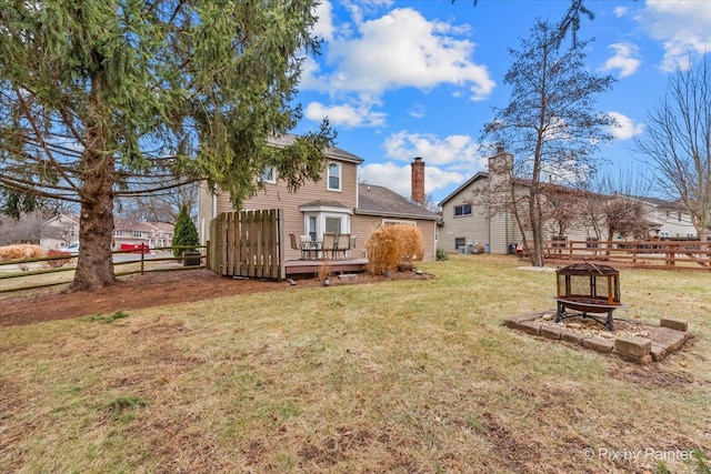 view of yard with a wooden deck and an outdoor fire pit