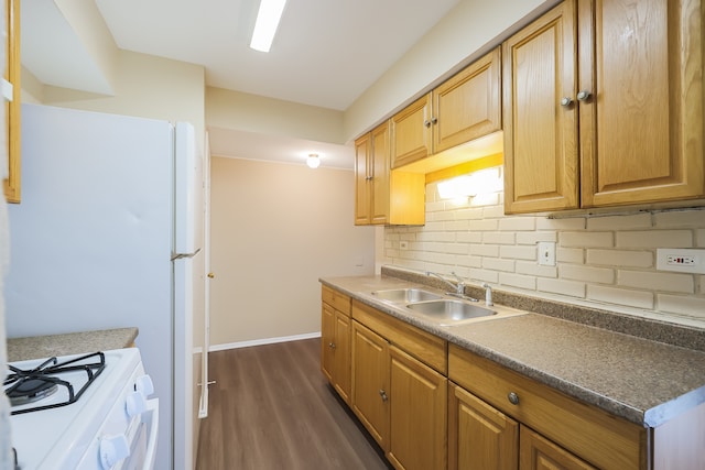 kitchen with white appliances, backsplash, sink, and dark hardwood / wood-style floors