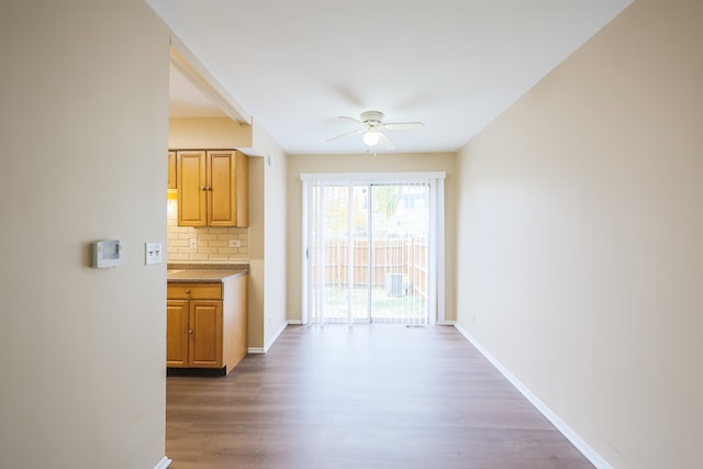 hallway with dark hardwood / wood-style flooring