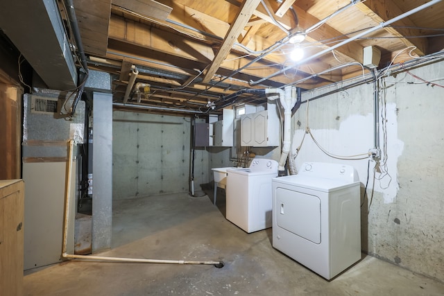 basement with heating unit and washing machine and clothes dryer