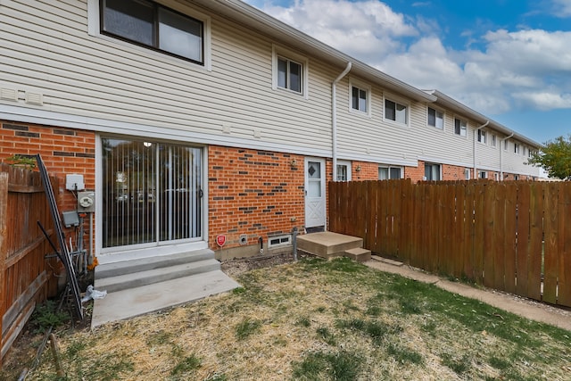 rear view of property with a yard