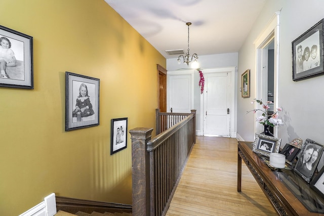 4533 Highland Ave, Downers Grove, IL 60515 - corridor featuring an upstairs landing, light wood finished floors, and a chandelier