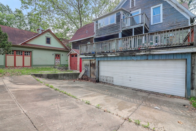4533 Highland Ave, Downers Grove, IL 60515 - back of house featuring a balcony, an attached garage, driveway, and an outbuilding