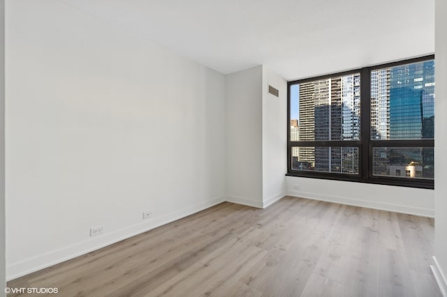 spare room featuring light hardwood / wood-style floors