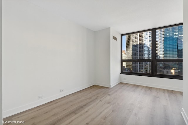 360 E Randolph St Unit 1807, Chicago, IL 60601 - unfurnished room with wood finished floors and baseboards