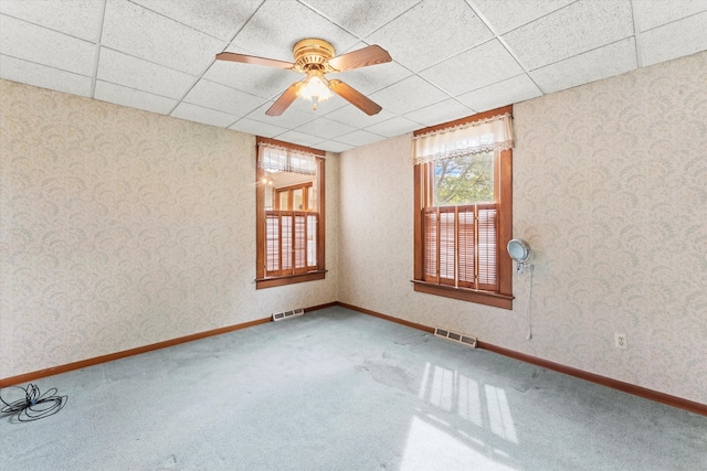 empty room with carpet, a paneled ceiling, and ceiling fan