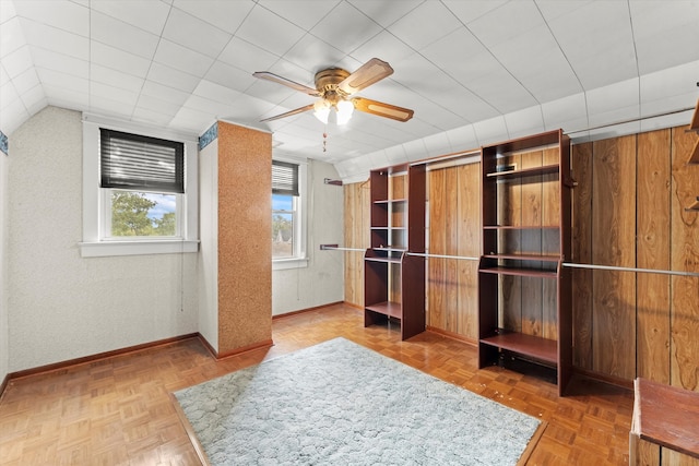 interior space featuring parquet flooring, lofted ceiling, and ceiling fan