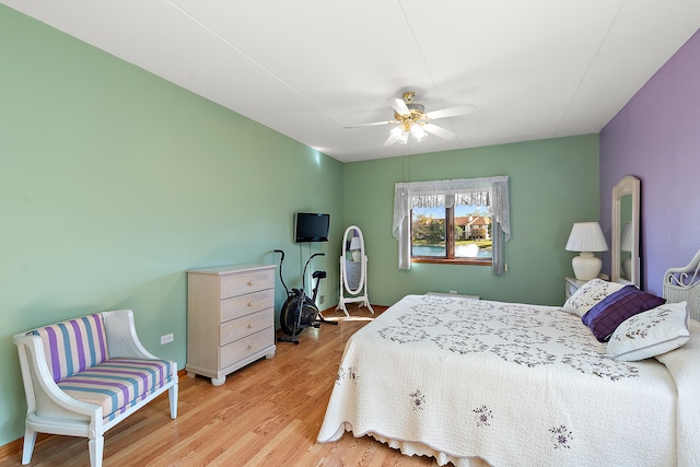 bedroom with light hardwood / wood-style flooring and ceiling fan