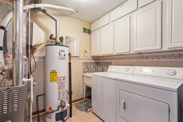 laundry room featuring cabinets, independent washer and dryer, and gas water heater