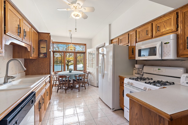 kitchen with white appliances, sink, ceiling fan, decorative light fixtures, and light tile patterned floors