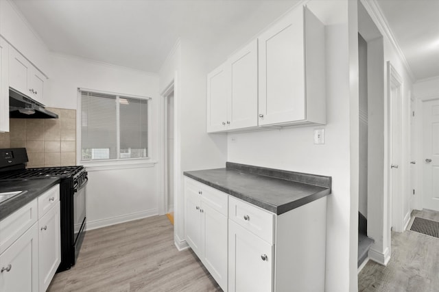 kitchen with black gas range, white cabinetry, light hardwood / wood-style flooring, and tasteful backsplash