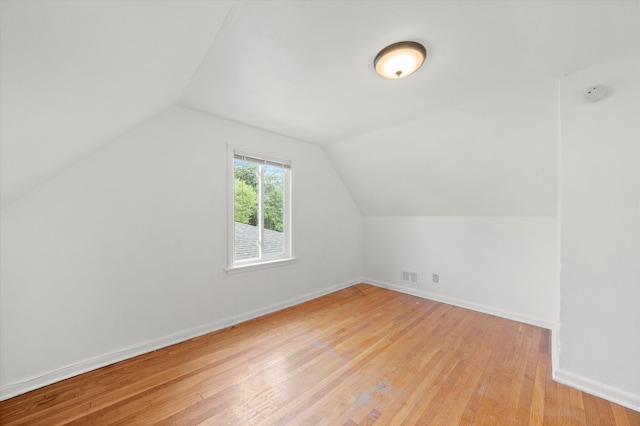 bonus room featuring lofted ceiling and light hardwood / wood-style floors