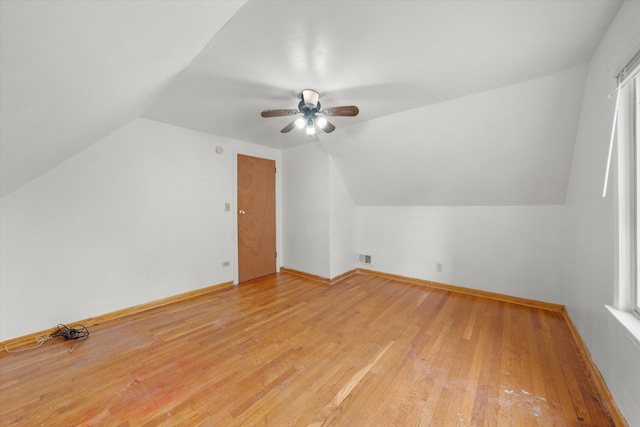 additional living space featuring vaulted ceiling, light hardwood / wood-style flooring, and ceiling fan